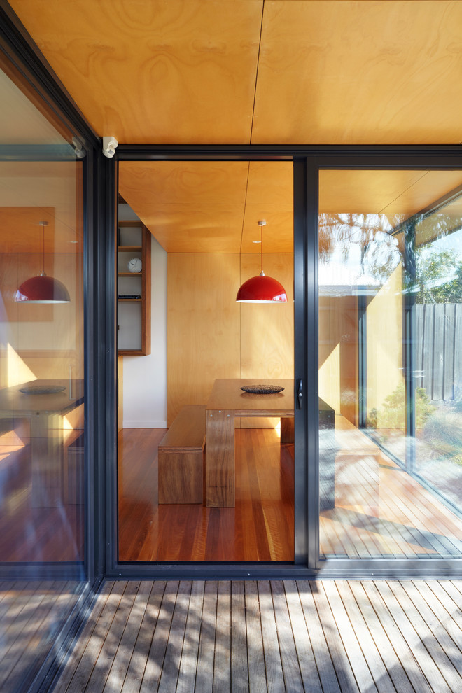 Inspiration for a mid-sized modern one-storey black exterior in Melbourne with wood siding and a flat roof.