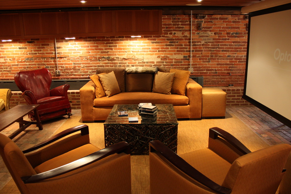 Large traditional enclosed home theatre in Other with red walls, brick floors, a projector screen and brown floor.