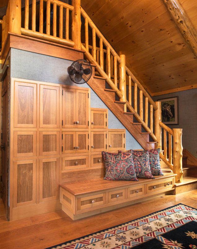 Large country loft-style bedroom in New York with brown walls, medium hardwood floors and brown floor.