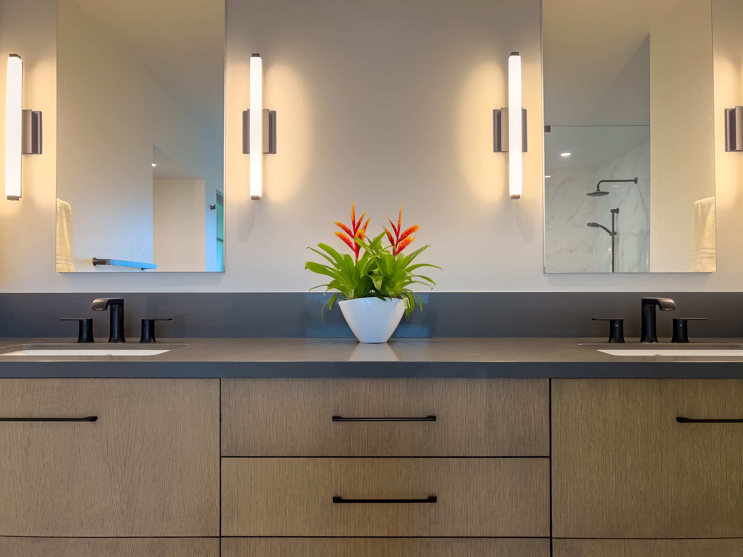 Example of a large trendy master white tile and marble tile porcelain tile, brown floor and double-sink bathroom design in San Francisco with flat-panel cabinets, medium tone wood cabinets, a one-piec