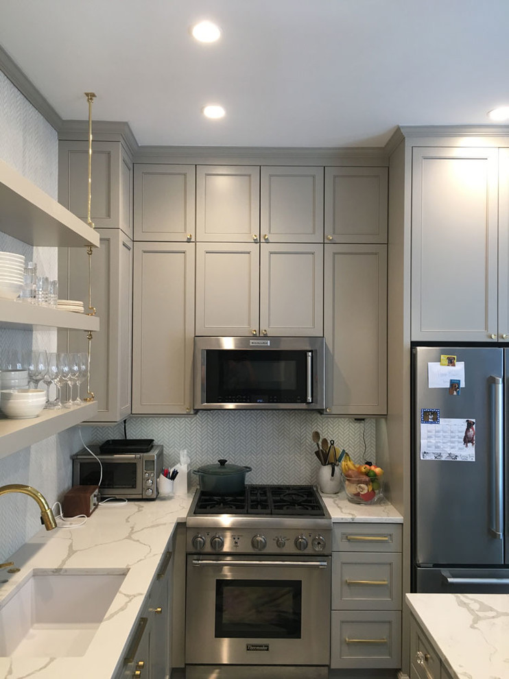 Inspiration for a mid-sized transitional l-shaped enclosed kitchen remodel in Chicago with an undermount sink, recessed-panel cabinets, gray cabinets, quartz countertops, white backsplash, mosaic tile backsplash, stainless steel appliances and an island