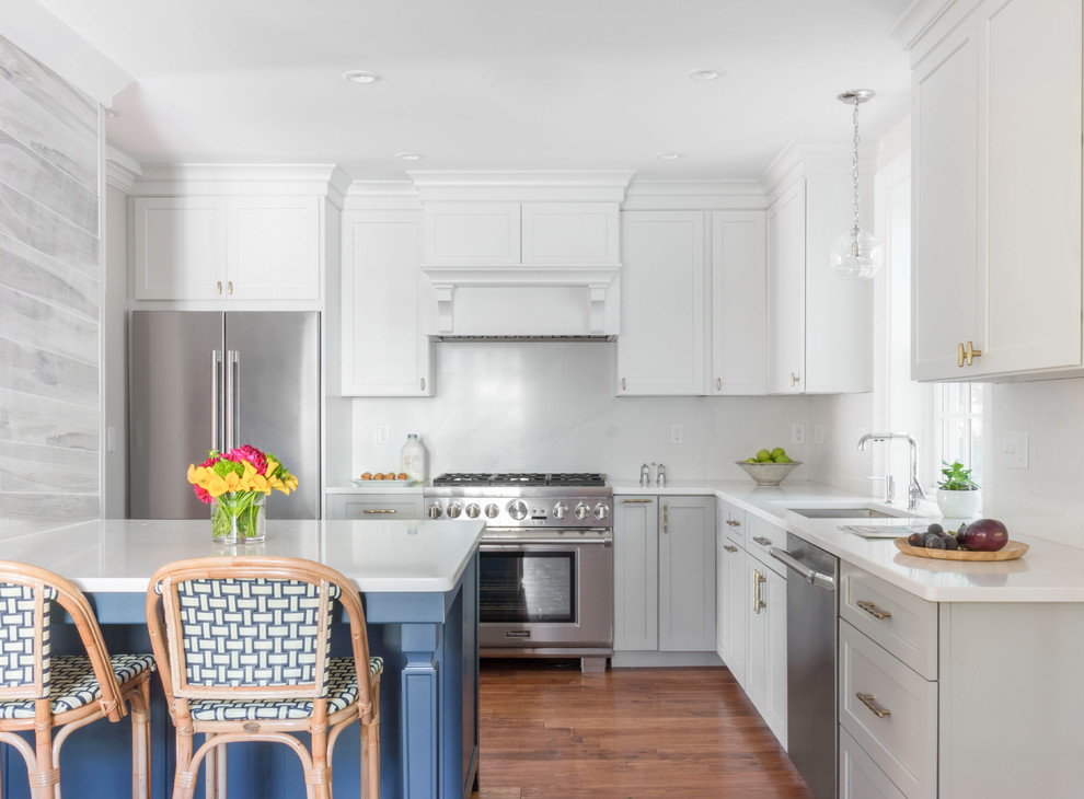 Mid-sized transitional l-shaped light wood floor and brown floor eat-in kitchen photo in Boston with a single-bowl sink, shaker cabinets, blue cabinets, quartzite countertops, white backsplash, stone slab backsplash, stainless steel appliances, an island and white countertops