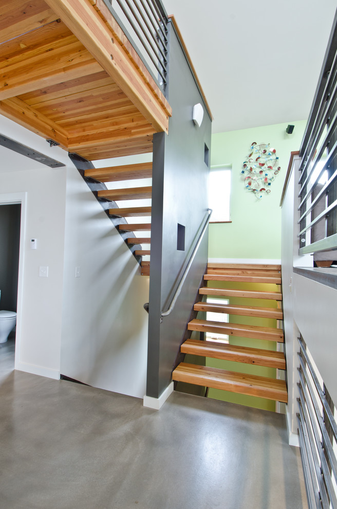 Large contemporary wood u-shaped staircase in Seattle with open risers.