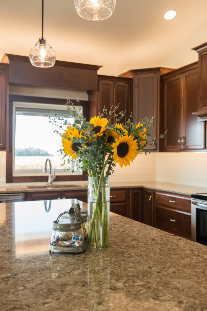 Open concept kitchen - large transitional l-shaped medium tone wood floor open concept kitchen idea with an undermount sink, flat-panel cabinets, medium tone wood cabinets, quartz countertops, white backsplash, ceramic backsplash, stainless steel appliances, an island and multicolored countertops