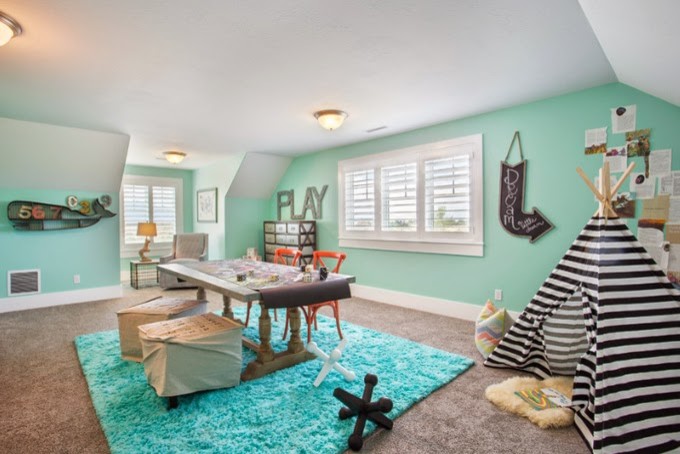 Inspiration for a large transitional gender-neutral kids' playroom for kids 4-10 years old in Salt Lake City with blue walls and carpet.