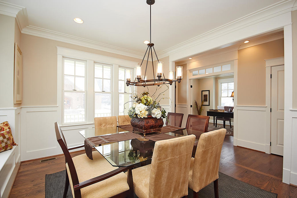 Large traditional separate dining room in DC Metro with beige walls, dark hardwood floors, no fireplace and brown floor.