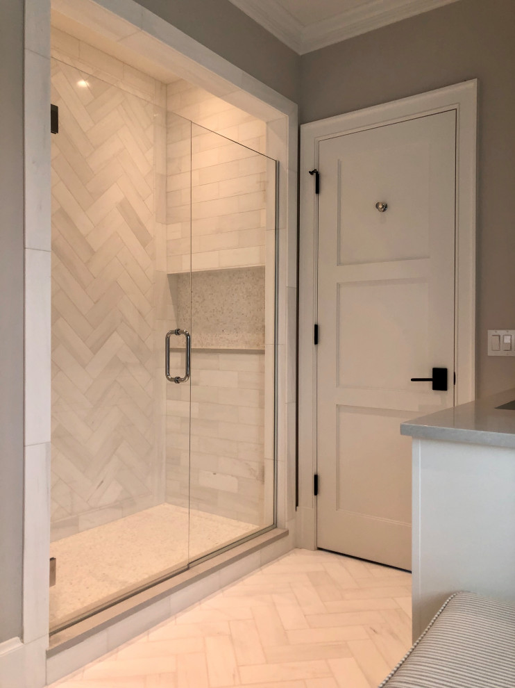 This is an example of a mid-sized country 3/4 bathroom in Chicago with recessed-panel cabinets, white cabinets, an alcove shower, grey walls, marble floors, an undermount sink, engineered quartz benchtops, white floor, a hinged shower door, grey benchtops, a double vanity and a built-in vanity.