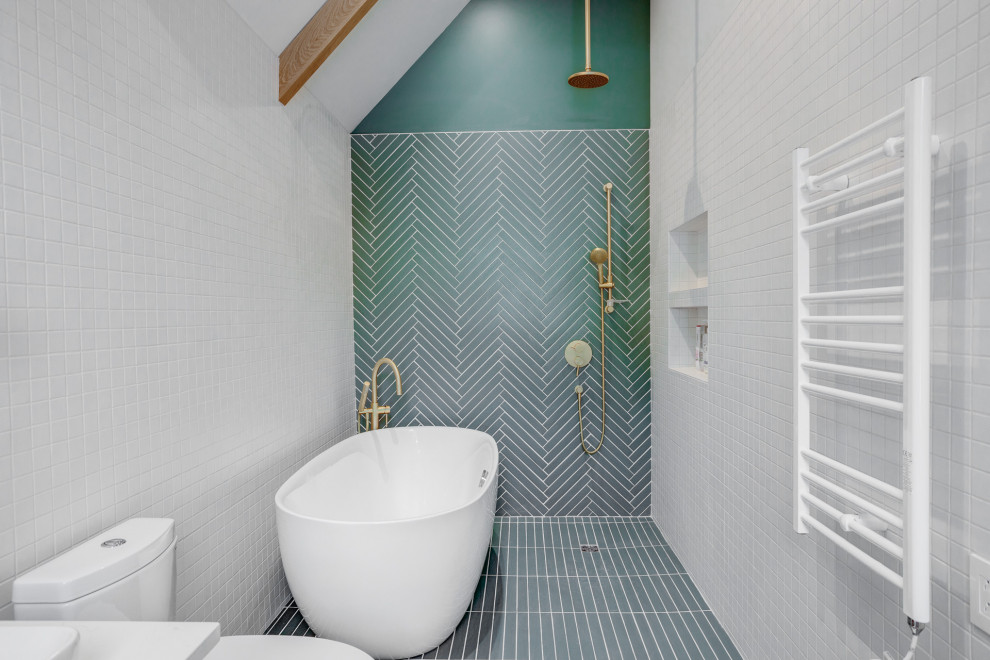 Medium sized scandinavian bathroom in Montreal with a freestanding bath, ceramic flooring, green floors, an open shower and a vaulted ceiling.
