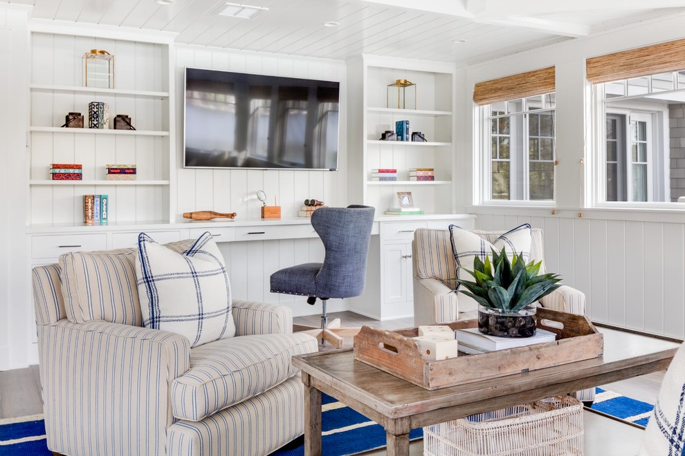 This is an example of a beach style study room in Los Angeles with a built-in desk and white walls.