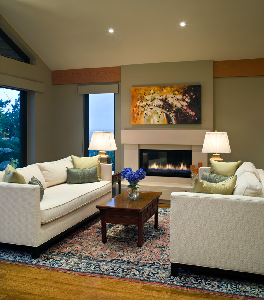 Photo of a contemporary living room in Vancouver with green walls and a ribbon fireplace.