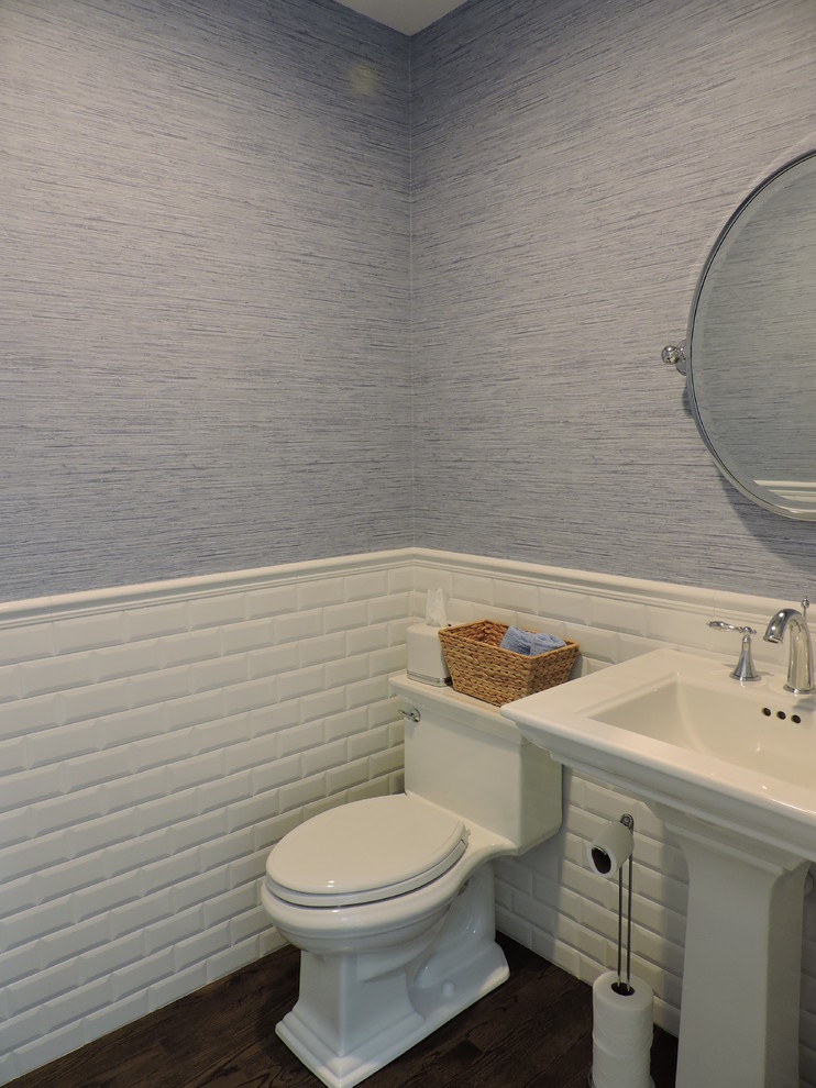 Inspiration for a mid-sized beach style 3/4 bathroom in New York with a pedestal sink, a one-piece toilet, white tile, subway tile, blue walls, dark hardwood floors and brown floor.