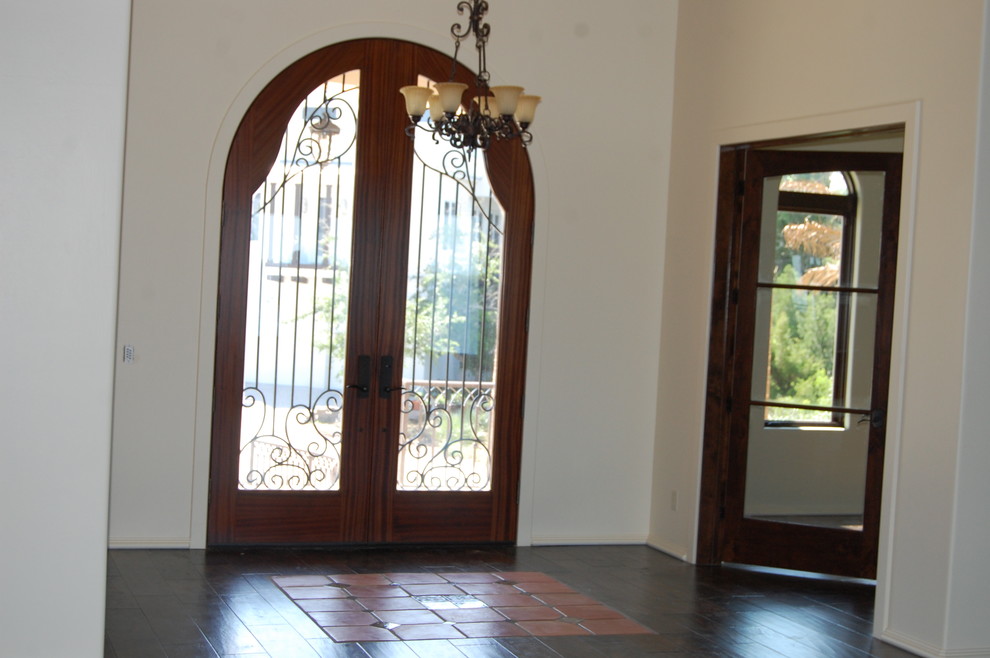 Front door - large rustic front door idea in Miami with beige walls and a dark wood front door