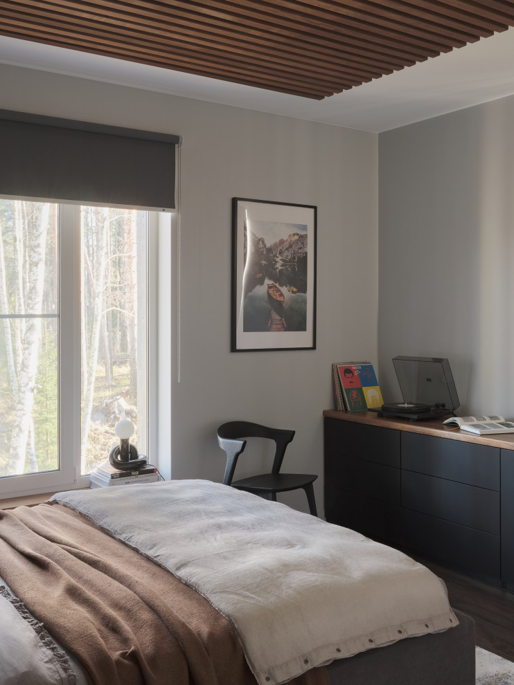 Inspiration for a mid-sized contemporary master bedroom in Saint Petersburg with grey walls, porcelain floors, brown floor and panelled walls.