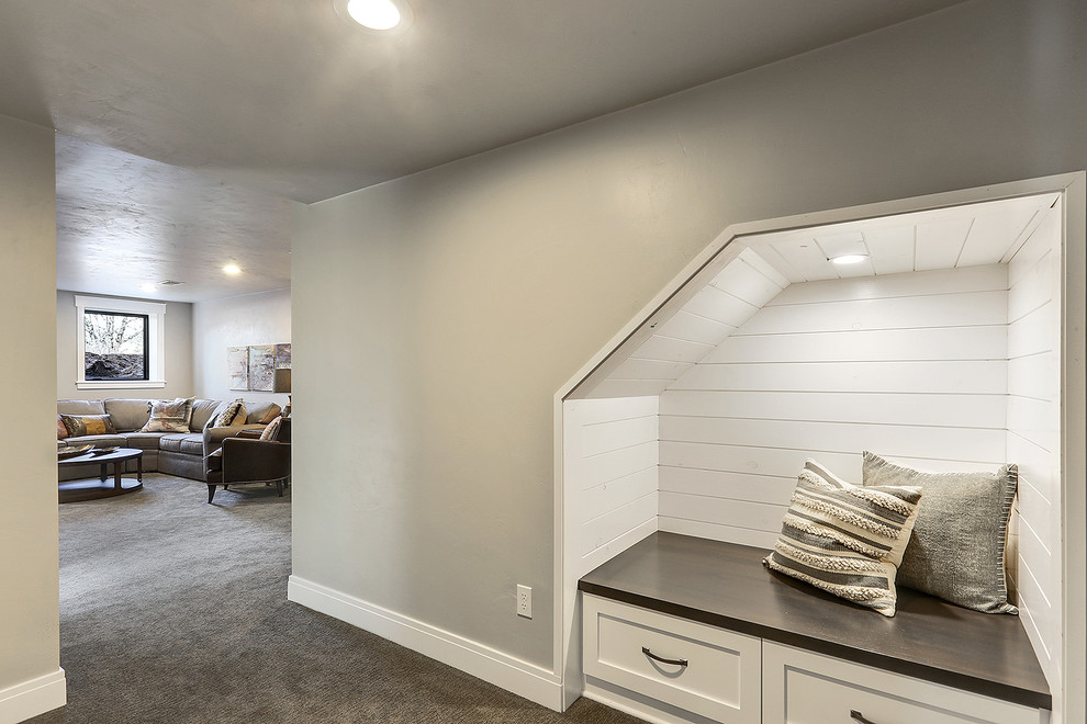 Traditional basement in Milwaukee with grey walls, carpet and grey floor.