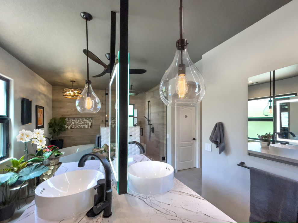 This is an example of a large transitional master bathroom in Orange County with shaker cabinets, grey cabinets, a freestanding tub, a double shower, a bidet, brown tile, wood-look tile, porcelain floors, a vessel sink, engineered quartz benchtops, grey floor, a hinged shower door, white benchtops, a niche, a double vanity and a built-in vanity.