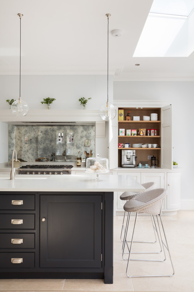 Inspiration for a mid-sized contemporary l-shaped kitchen in London with recessed-panel cabinets, blue cabinets, quartzite benchtops, metallic splashback, mirror splashback and with island.
