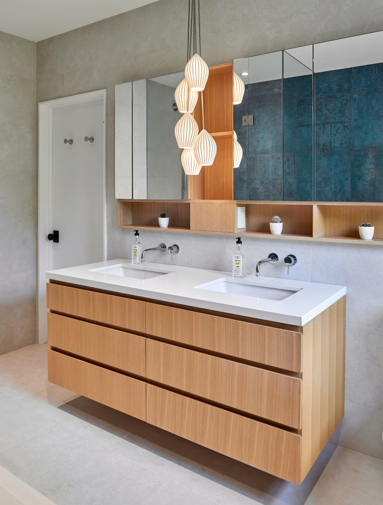 Photo of an expansive contemporary master bathroom in Toronto with flat-panel cabinets, brown cabinets, a drop-in tub, a corner shower, multi-coloured tile, porcelain tile, multi-coloured walls, porcelain floors, an undermount sink, engineered quartz benchtops, beige floor, a hinged shower door, white benchtops, a double vanity and a floating vanity.
