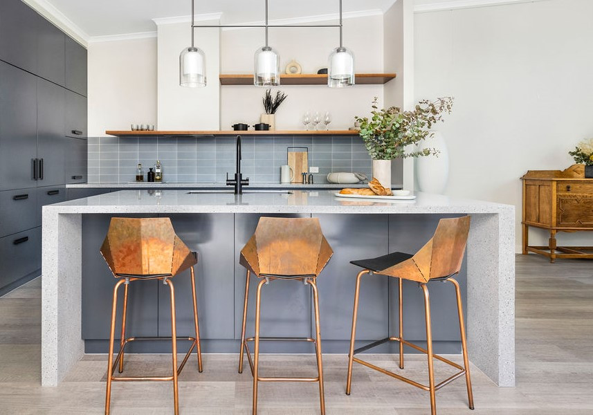 Mid-sized contemporary l-shaped kitchen pantry in Canberra - Queanbeyan with an undermount sink, flat-panel cabinets, blue cabinets, terrazzo benchtops, blue splashback, subway tile splashback, black appliances, laminate floors, with island, beige floor, blue benchtop and vaulted.