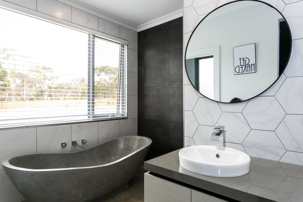 Design ideas for a mid-sized contemporary master bathroom in Adelaide with flat-panel cabinets, grey cabinets, a freestanding tub, an open shower, a one-piece toilet, gray tile, porcelain tile, grey walls, porcelain floors, a drop-in sink, solid surface benchtops, brown floor, an open shower, grey benchtops, a single vanity and a built-in vanity.
