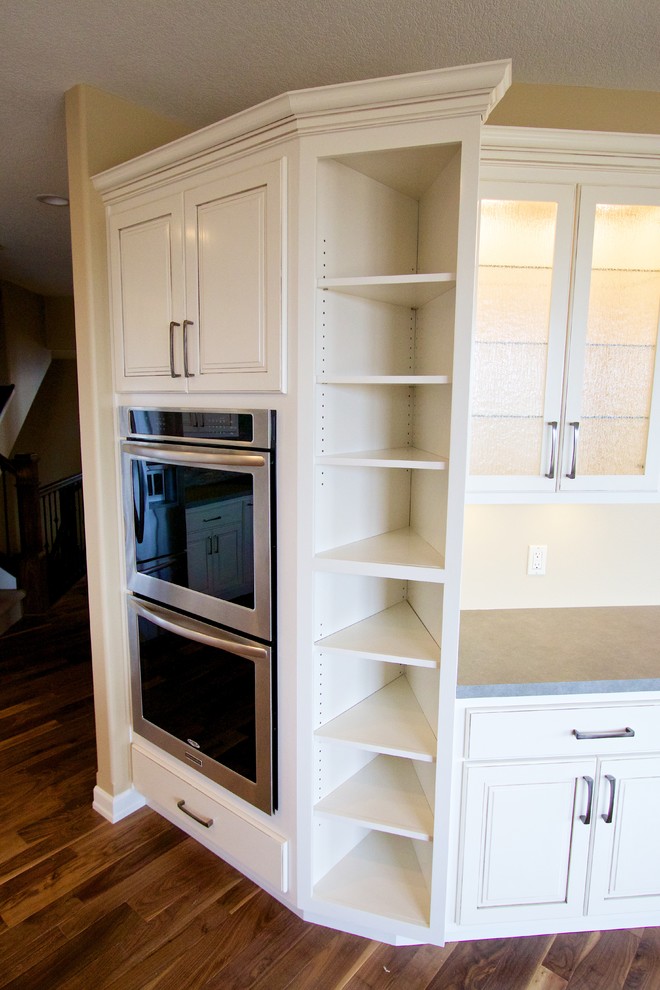 Inspiration for a huge open concept kitchen remodel with a drop-in sink, raised-panel cabinets, white cabinets, multicolored backsplash, stone tile backsplash, stainless steel appliances and an island