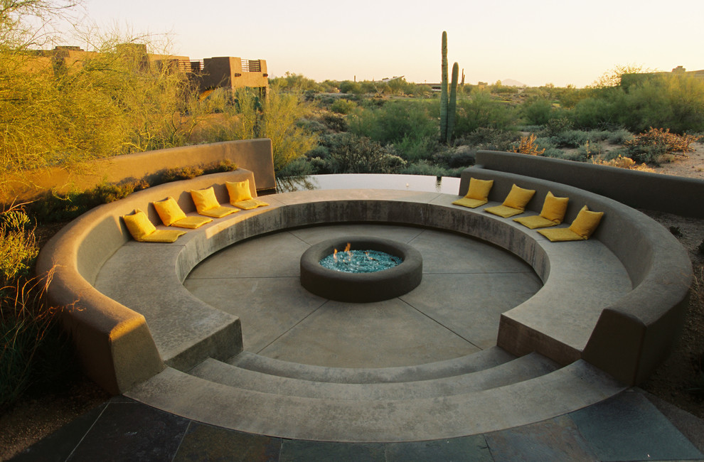 Design ideas for a mediterranean patio in Phoenix with a fire feature, concrete slab and no cover.