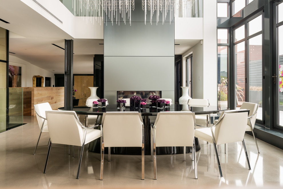 Contemporary dining room in Montreal with white walls and a standard fireplace.