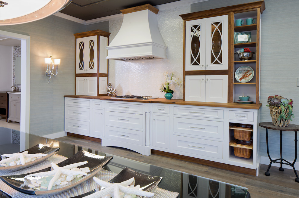 Eat-in kitchen - mid-sized transitional single-wall medium tone wood floor eat-in kitchen idea in Orange County with shaker cabinets, white cabinets, wood countertops, white backsplash, stainless steel appliances and no island