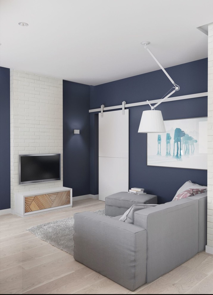 Photo of a small scandinavian formal loft-style living room in Other with blue walls, light hardwood floors and a wall-mounted tv.