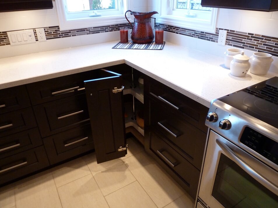 Inspiration for a transitional porcelain tile and beige floor eat-in kitchen remodel in Toronto with a double-bowl sink, shaker cabinets, dark wood cabinets, quartz countertops, white backsplash, subway tile backsplash, stainless steel appliances and white countertops