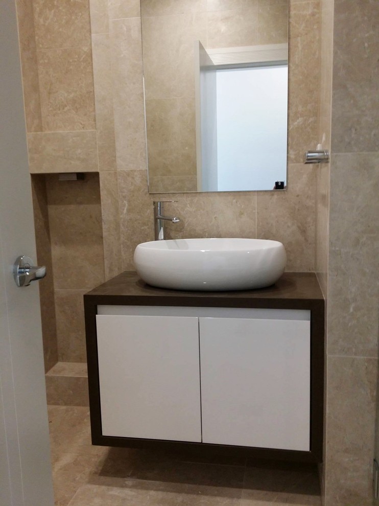 Design ideas for a mid-sized modern 3/4 bathroom in Sydney with flat-panel cabinets, white cabinets, an open shower, a two-piece toilet, beige tile, stone tile, beige walls, marble floors, a trough sink and engineered quartz benchtops.