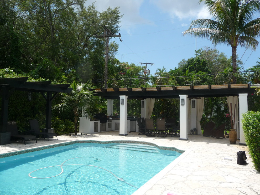 Tropical pool in Miami with natural stone pavers.
