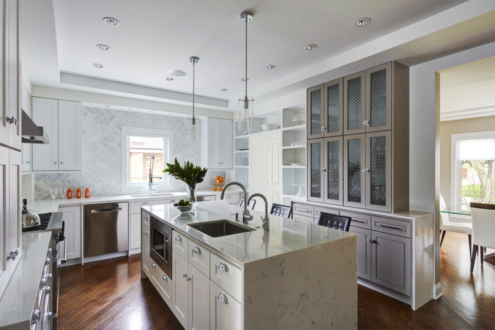 Inspiration for a mid-sized transitional u-shaped medium tone wood floor eat-in kitchen remodel in Chicago with an undermount sink, shaker cabinets, white cabinets, solid surface countertops, blue backsplash, stone tile backsplash, stainless steel appliances and an island