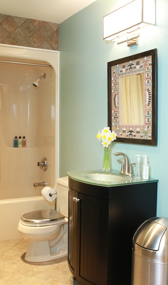 Inspiration for a small eclectic kids bathroom in Chicago with an integrated sink, beaded inset cabinets, black cabinets, glass benchtops, an alcove tub, a two-piece toilet, multi-coloured tile, ceramic tile, blue walls and ceramic floors.