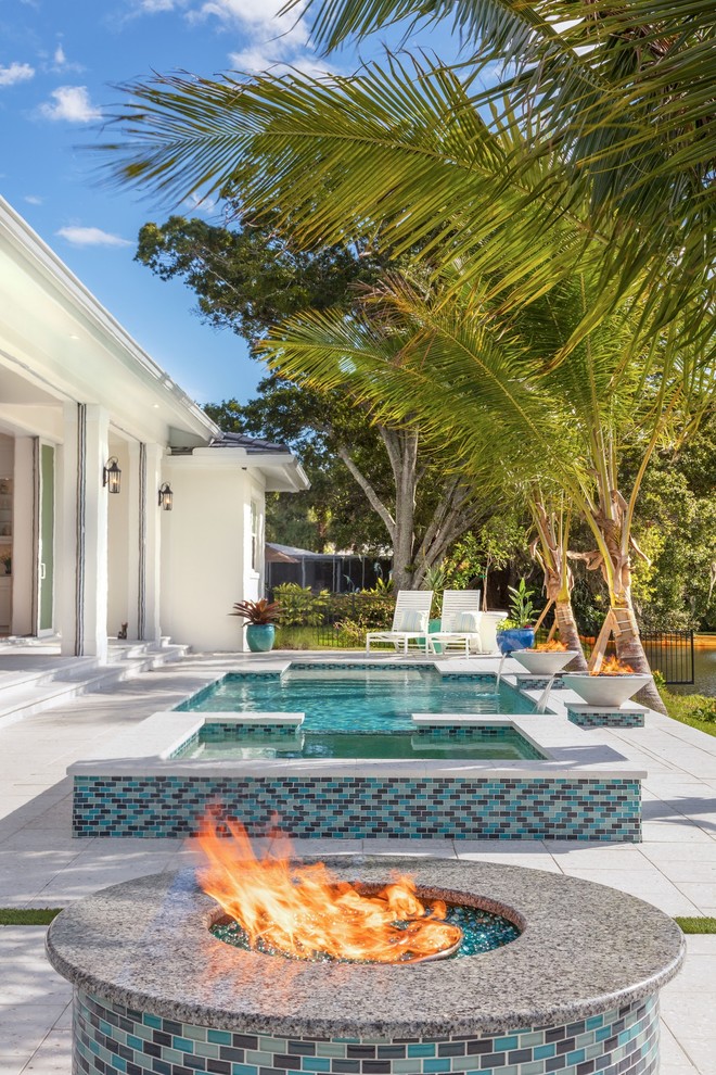 Trendy backyard concrete paver and rectangular hot tub photo in Tampa