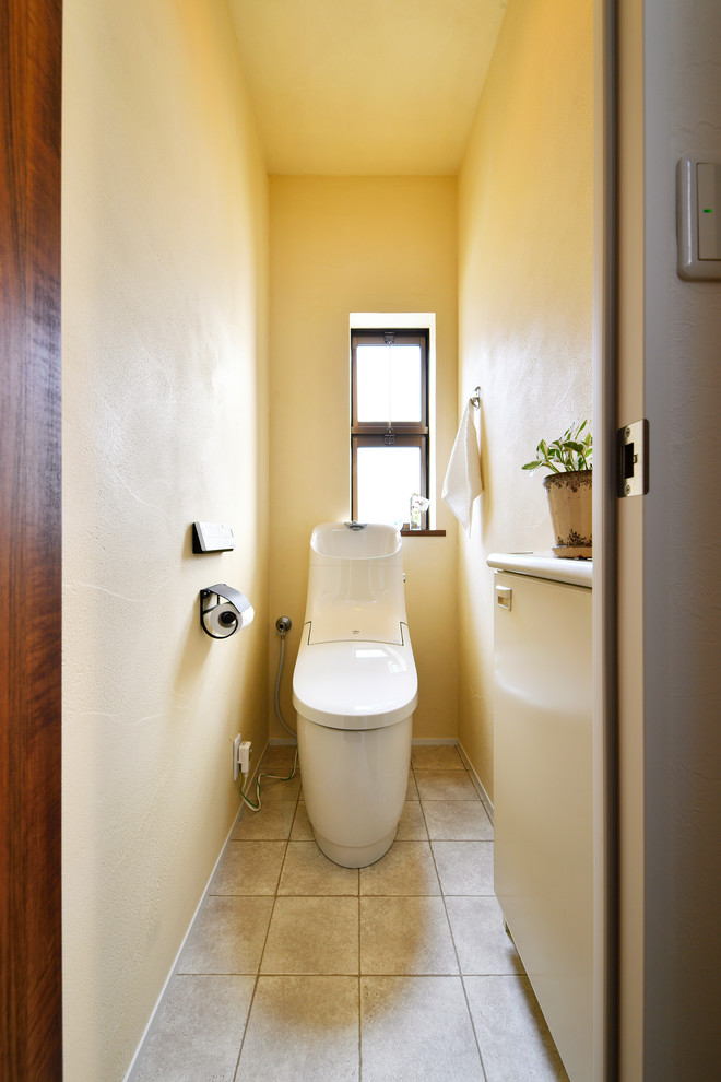 This is an example of a scandinavian powder room in Other with beige walls and beige floor.