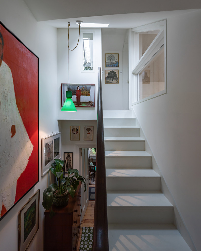 Design ideas for a mid-sized eclectic wood staircase in London with wood risers.