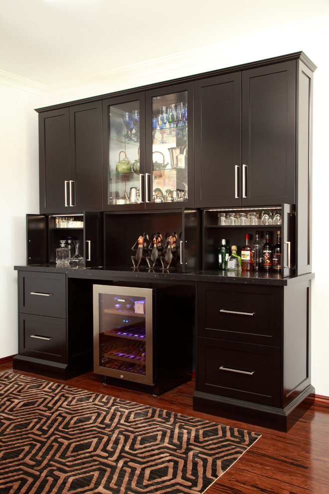 Small transitional home bar in Perth with bamboo floors.
