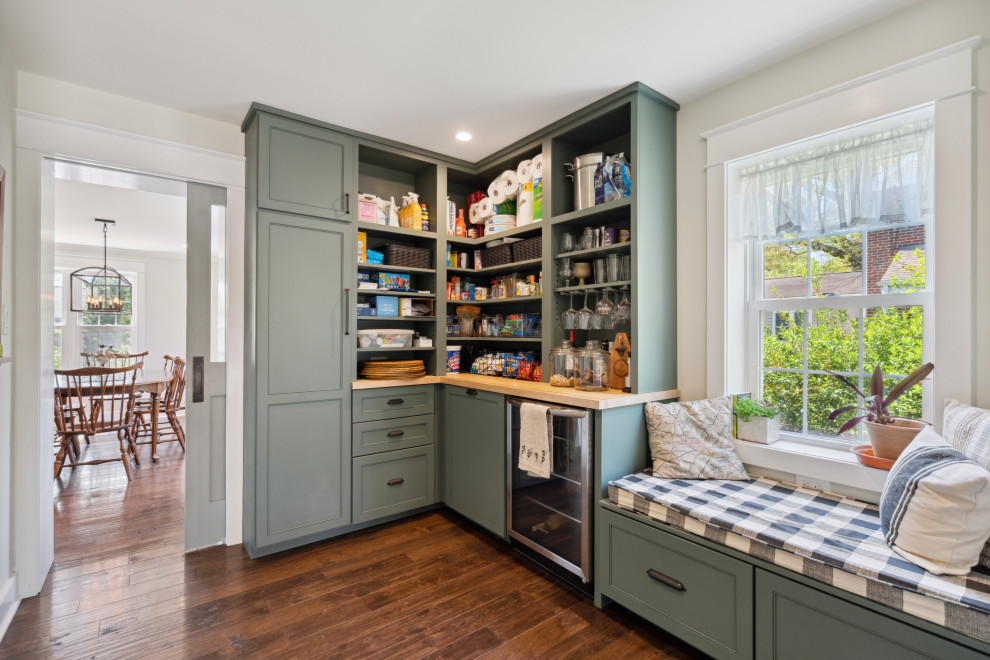 Photo of a mid-sized country l-shaped kitchen pantry in Philadelphia with open cabinets, green cabinets, wood benchtops, stainless steel appliances, dark hardwood floors, no island, brown floor and yellow benchtop.
