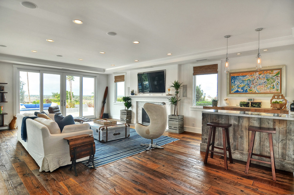 Photo of a large country formal open concept living room in Orange County with white walls, dark hardwood floors, a standard fireplace, a tile fireplace surround, a wall-mounted tv and brown floor.