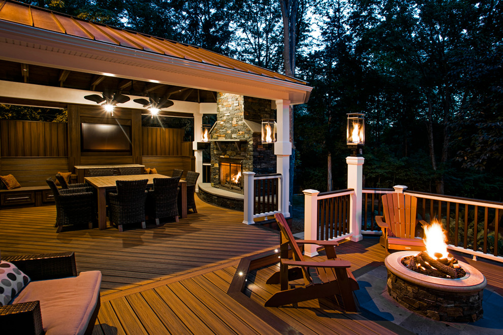 Large mountain style backyard outdoor kitchen deck photo in DC Metro with a pergola