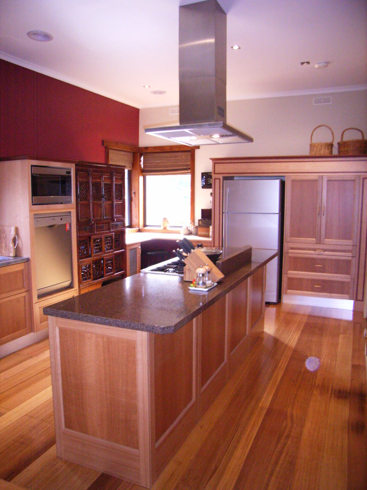 Design ideas for a mid-sized contemporary galley eat-in kitchen in Melbourne with a drop-in sink, shaker cabinets, light wood cabinets, quartz benchtops, red splashback, glass sheet splashback, coloured appliances, light hardwood floors and with island.