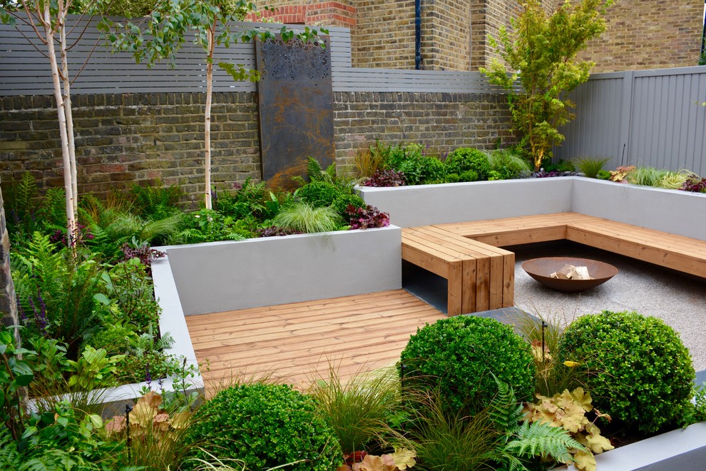 This is an example of a small contemporary backyard partial sun garden in London.