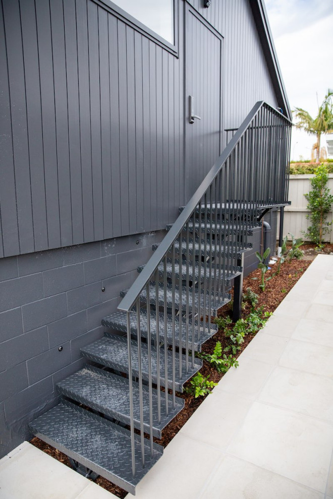 This is an example of a mid-sized industrial metal floating staircase in Auckland with open risers and metal railing.