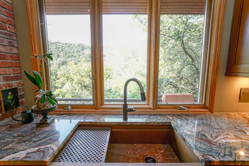Kitchen - mid-sized transitional medium tone wood floor and brown floor kitchen idea in Denver with a farmhouse sink, recessed-panel cabinets, medium tone wood cabinets, granite countertops, paneled appliances and an island