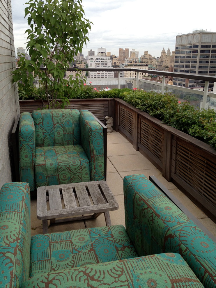 Example of a large minimalist rooftop balcony container garden design in Jacksonville with an awning