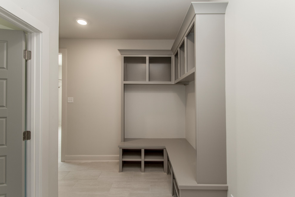 Design ideas for a mid-sized transitional mudroom in Little Rock with grey walls, porcelain floors and beige floor.