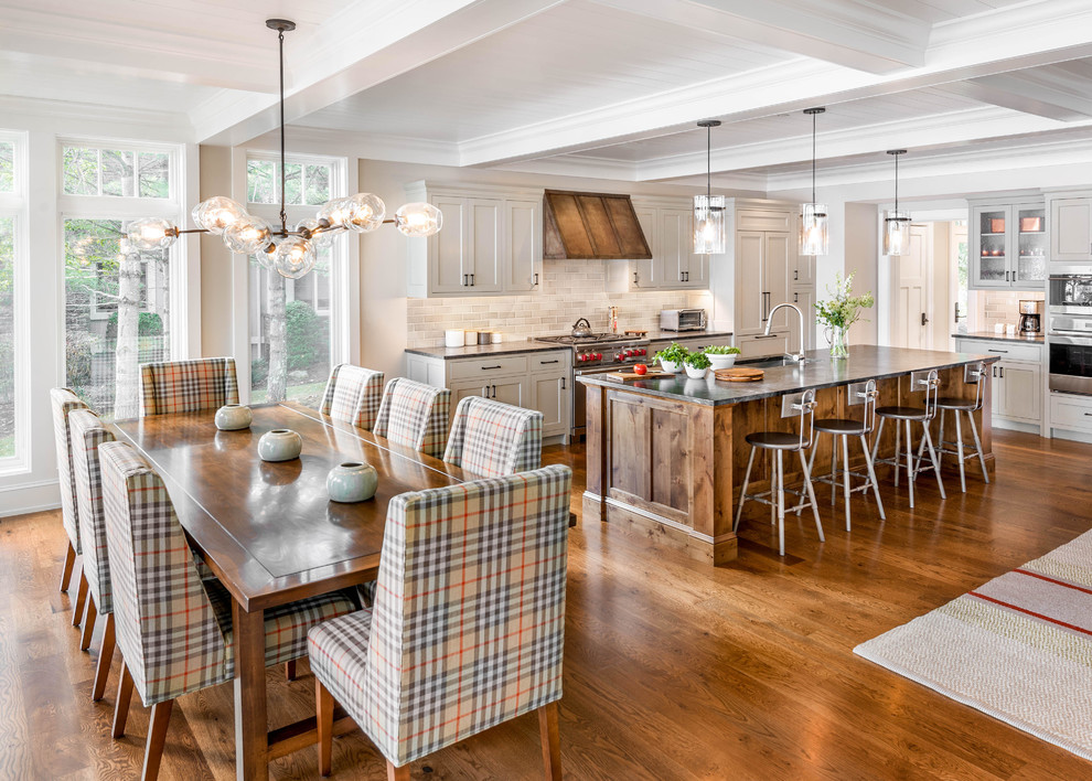 Transitional l-shaped medium tone wood floor and brown floor eat-in kitchen photo in Burlington with an undermount sink, recessed-panel cabinets, beige cabinets, beige backsplash, subway tile backsplash, stainless steel appliances, an island and gray countertops