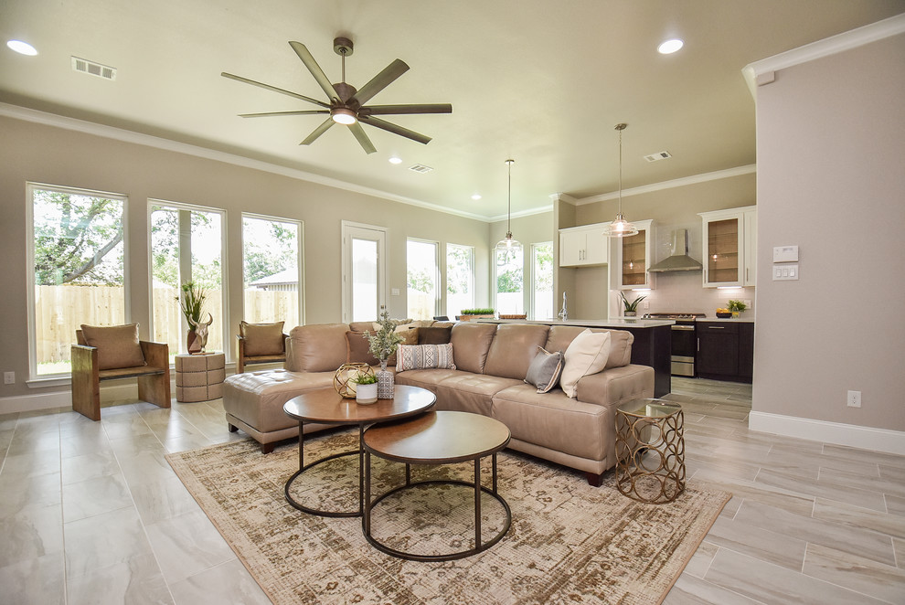 Inspiration for a mid-sized transitional open concept living room in Houston with beige walls, porcelain floors, no fireplace, a freestanding tv and multi-coloured floor.