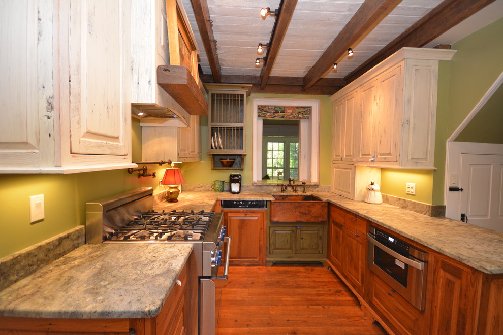 Inspiration for a mid-sized country galley eat-in kitchen in DC Metro with a farmhouse sink, raised-panel cabinets, medium wood cabinets, granite benchtops, green splashback, stainless steel appliances, medium hardwood floors and a peninsula.