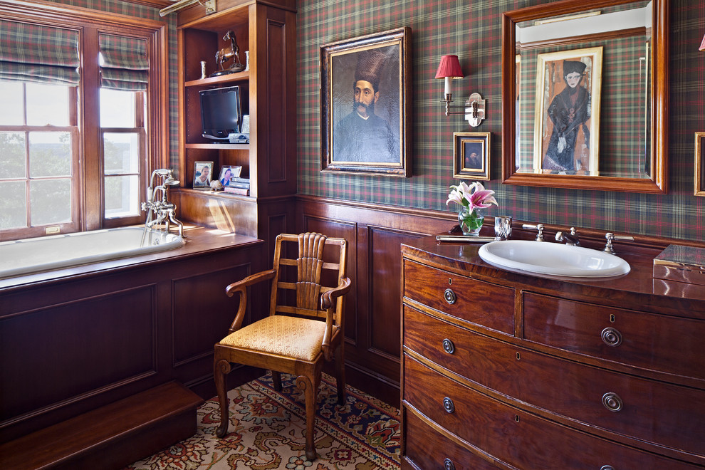 Design ideas for a country bathroom in New York with a drop-in sink, medium wood cabinets, wood benchtops, a drop-in tub, multi-coloured walls, brown benchtops and flat-panel cabinets.